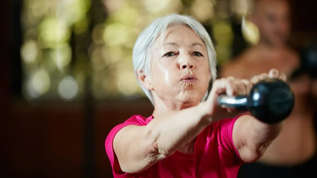Toning Arms Without the Bulk: Is It Achievable? 1 Woman doing resistance band exercises for toned arms Epping